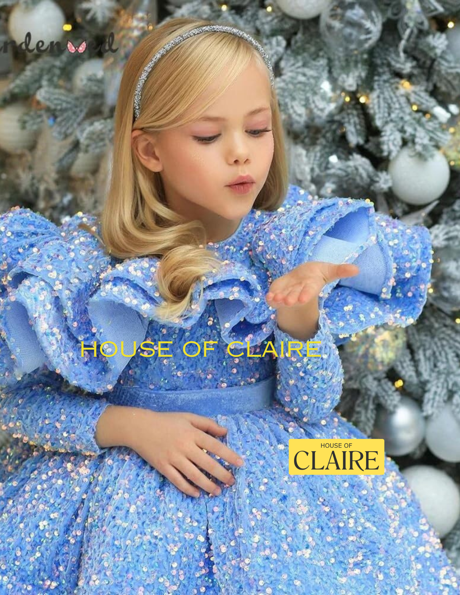 A young girl with blonde hair wearing a sparkly light blue sequined ballgown and a silver headband, posing in front of a decorated Christmas tree. The brand name 'HOUSE OF CLAIRE' is watermarked on the image.
Luxury Lavendar Blue Sparkle Baby Birthday Party Ball Gown Dress by house of Claire.
www.houseofclaire.com
